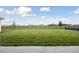 View of large fenced backyard with vibrant green lawn, offering privacy and a secure outdoor space at 10320 Longmeadow Ave, Parrish, FL 34219