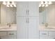 Bathroom featuring a double vanity and white cabinets with chrome hardware at 10320 Longmeadow Ave, Parrish, FL 34219