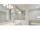 Bright bathroom features a double vanity, a framed mirror, and a shower at 10320 Longmeadow Ave, Parrish, FL 34219