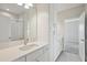 Bathroom with a double sink vanity, cabinets, and a walk-in shower at 10320 Longmeadow Ave, Parrish, FL 34219