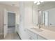 Bathroom featuring double vanity and a door leading to the bedroom at 10320 Longmeadow Ave, Parrish, FL 34219