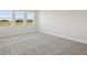 Bedroom with carpet and natural light streaming through three windows at 10320 Longmeadow Ave, Parrish, FL 34219