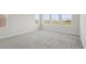 Spacious bedroom with plush carpeting and natural light from three windows at 10320 Longmeadow Ave, Parrish, FL 34219