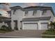 Traditional-style home with a three-car garage, a well-manicured lawn, and stone accents at 10320 Longmeadow Ave, Parrish, FL 34219