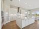 Modern kitchen featuring white cabinets, a central island, and stainless steel appliances at 10320 Longmeadow Ave, Parrish, FL 34219