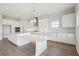 Stylish kitchen boasting white cabinets, modern appliances, and quartz countertops, complete with a spacious island at 10320 Longmeadow Ave, Parrish, FL 34219