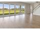 Bright and open living area with wood flooring, large sliding glass doors, and lots of natural light at 10320 Longmeadow Ave, Parrish, FL 34219