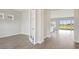 Bright living area featuring wood floors, large windows, and open view to the backyard at 10320 Longmeadow Ave, Parrish, FL 34219