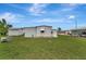 View of the backyard featuring a shed, trees and green grass at 104 E Saint Johns Way, Apollo Beach, FL 33572