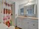 Bathroom featuring a shower, toilet and vanity with a mirror and storage at 104 E Saint Johns Way, Apollo Beach, FL 33572
