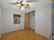 Bright bedroom with light wood floors, a ceiling fan and a closet at 104 E Saint Johns Way, Apollo Beach, FL 33572