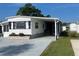 Charming home featuring a covered driveway, clean landscaping, and a well-maintained exterior at 104 E Saint Johns Way, Apollo Beach, FL 33572
