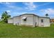 Home exterior featuring green grass, shed, and metal siding at 104 E Saint Johns Way, Apollo Beach, FL 33572