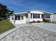 Exterior of well maintained home featuring carport, colorful shutters, and landscaping at 104 E Saint Johns Way, Apollo Beach, FL 33572