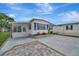 Inviting home with a covered parking, well-kept landscaping, and a concrete driveway at 104 E Saint Johns Way, Apollo Beach, FL 33572