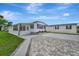 Charming single-story home with neat landscaping, a long driveway and a carport at 104 E Saint Johns Way, Apollo Beach, FL 33572