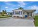 Single-story home with a carport and neat landscaping at 104 E Saint Johns Way, Apollo Beach, FL 33572