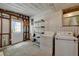 Functional laundry room with washer, dryer, and shelving, ready for your appliances at 104 E Saint Johns Way, Apollo Beach, FL 33572