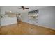 A well-lit open-concept living area features wood-look floors, white walls, and a ceiling fan at 104 E Saint Johns Way, Apollo Beach, FL 33572