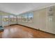 Bright living room featuring wood floors and wall-to-wall windows at 104 E Saint Johns Way, Apollo Beach, FL 33572