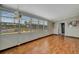 Well-lit living room with lots of windows and wood floors at 104 E Saint Johns Way, Apollo Beach, FL 33572