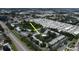 Community aerial showcasing a pool and pond with mature trees near a main road at 11201 122Nd Ave # 167, Largo, FL 33778