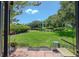 Inviting backyard features a lush lawn, mature landscaping, and tranquil pond view at 11201 122Nd Ave # 167, Largo, FL 33778