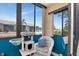 Enclosed balcony featuring a cat tree, seating and neighborhood views at 11201 122Nd Ave # 167, Largo, FL 33778