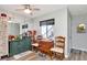 Functional dining area with mirrored wall, ceiling fan and a view to the outside at 11201 122Nd Ave # 167, Largo, FL 33778