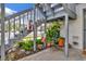 Staircase leading to an upper-level unit with colorful potted plants creating a welcoming entrance at 11201 122Nd Ave # 167, Largo, FL 33778