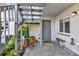 Inviting entrance area with a bench, potted plants, and a unique metal sculpture at 11201 122Nd Ave # 167, Largo, FL 33778