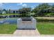 Outdoor grill area by the pond, perfect for barbecues at 11201 122Nd Ave # 167, Largo, FL 33778