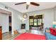 Inviting living room featuring a ceiling fan, entertainment center, and view of an enclosed sunroom at 11201 122Nd Ave # 167, Largo, FL 33778