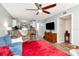 Open living room with ceiling fan, breakfast bar, and comfortable seating arrangement at 11201 122Nd Ave # 167, Largo, FL 33778