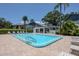 Community pool with lounge chairs and covered area for relaxation at 11201 122Nd Ave # 167, Largo, FL 33778