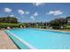 Community pool and sun loungers overlook well-maintained landscaping and ponds at 11201 122Nd Ave # 167, Largo, FL 33778