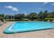 Community pool with well-manicured landscaping and pond views at 11201 122Nd Ave # 167, Largo, FL 33778