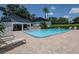 Relaxing community pool with lounge chairs, shade, and serene pond views at 11201 122Nd Ave # 167, Largo, FL 33778