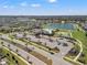 Aerial view of the community amenities, including a pool, pickleball courts, parking, and a lake at 11508 Sage Canyon Dr, Riverview, FL 33578