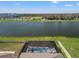 Aerial view of a lakefront home with a private screened pool and patio area at 11508 Sage Canyon Dr, Riverview, FL 33578