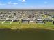 Aerial view of the back of several homes, each with private pools and lake views at 11508 Sage Canyon Dr, Riverview, FL 33578