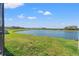 Spacious backyard with lake view, well-maintained lawn and partial fencing at 11508 Sage Canyon Dr, Riverview, FL 33578