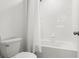 Bright bathroom with a white tiled tub and shower combination, providing a clean and simple design at 11508 Sage Canyon Dr, Riverview, FL 33578