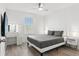 Bedroom featuring wood-look floors, a grey quilted bedspread, and a lighted makeup mirror at 11508 Sage Canyon Dr, Riverview, FL 33578