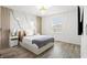 Stylish bedroom featuring a decorative accent wall, modern lighting, and hardwood flooring at 11508 Sage Canyon Dr, Riverview, FL 33578
