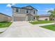 Well-maintained two-story home with a spacious driveway, a two-car garage, and a nicely landscaped front yard at 11508 Sage Canyon Dr, Riverview, FL 33578