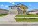 Charming two-story home with a well-manicured lawn, a concrete driveway, and a two-car garage at 11508 Sage Canyon Dr, Riverview, FL 33578