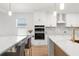Modern kitchen with stainless appliances, double islands, marble countertops, and stylish pendant lighting at 11508 Sage Canyon Dr, Riverview, FL 33578