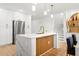 Modern kitchen with stainless steel appliances, a large island with marble countertop, and stylish pendant lights at 11508 Sage Canyon Dr, Riverview, FL 33578