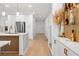 Modern kitchen with island, stainless steel appliances, decorative shelving and hallway at 11508 Sage Canyon Dr, Riverview, FL 33578